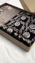 Detailed close-up view of the dense Sona Rupa Jangla floral and vine pattern woven across the black katan silk saree.