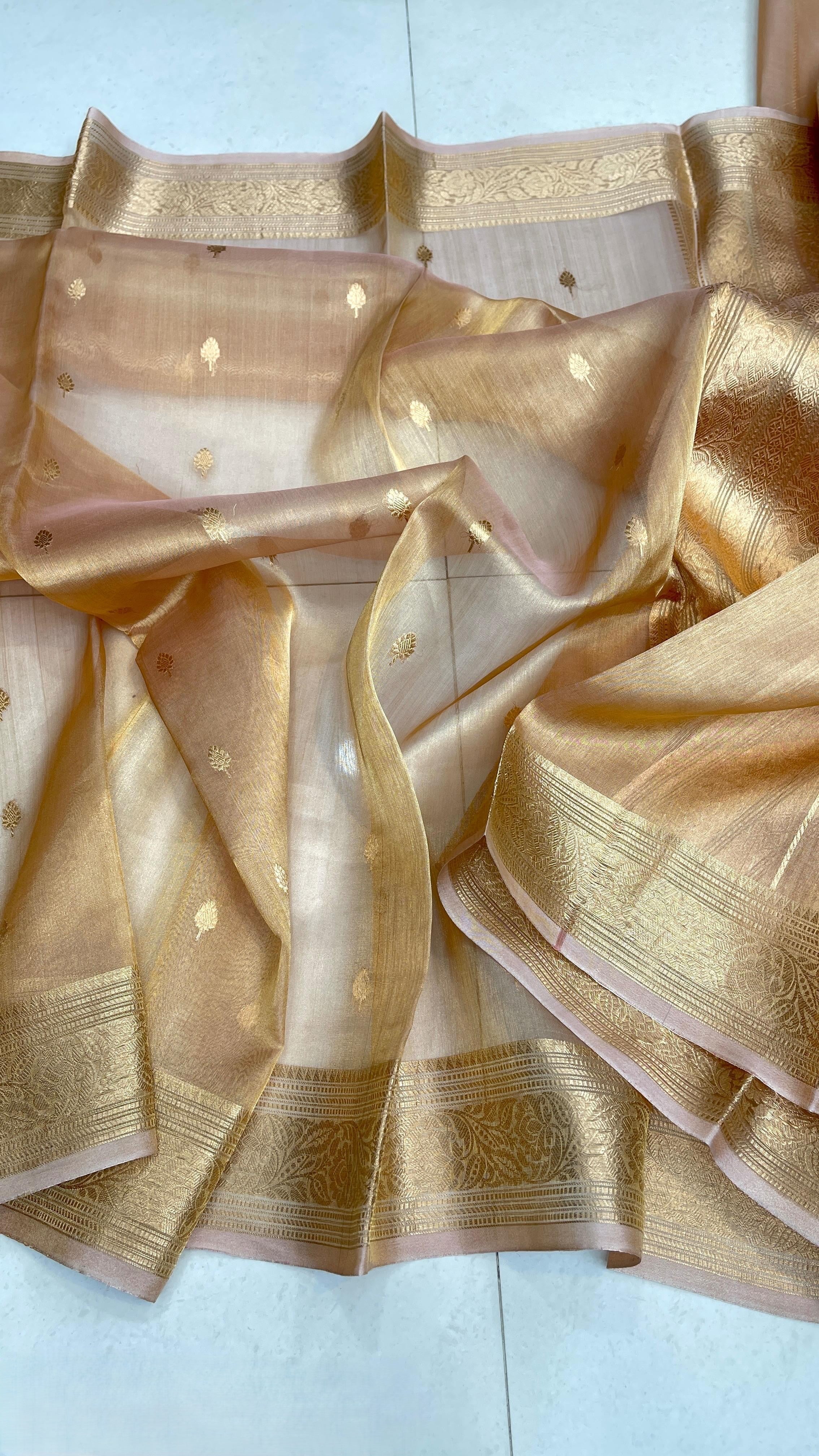 Gold Banarasi handloom kora tissue silk saree featuring shimmering antique zari weaving, delicate body buttas, and a certified authentic finish.