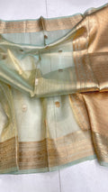 Pista Green Banarasi handloom kora tissue silk saree featuring shimmering antique zari weaving, delicate body buttas, and a certified authentic finish.