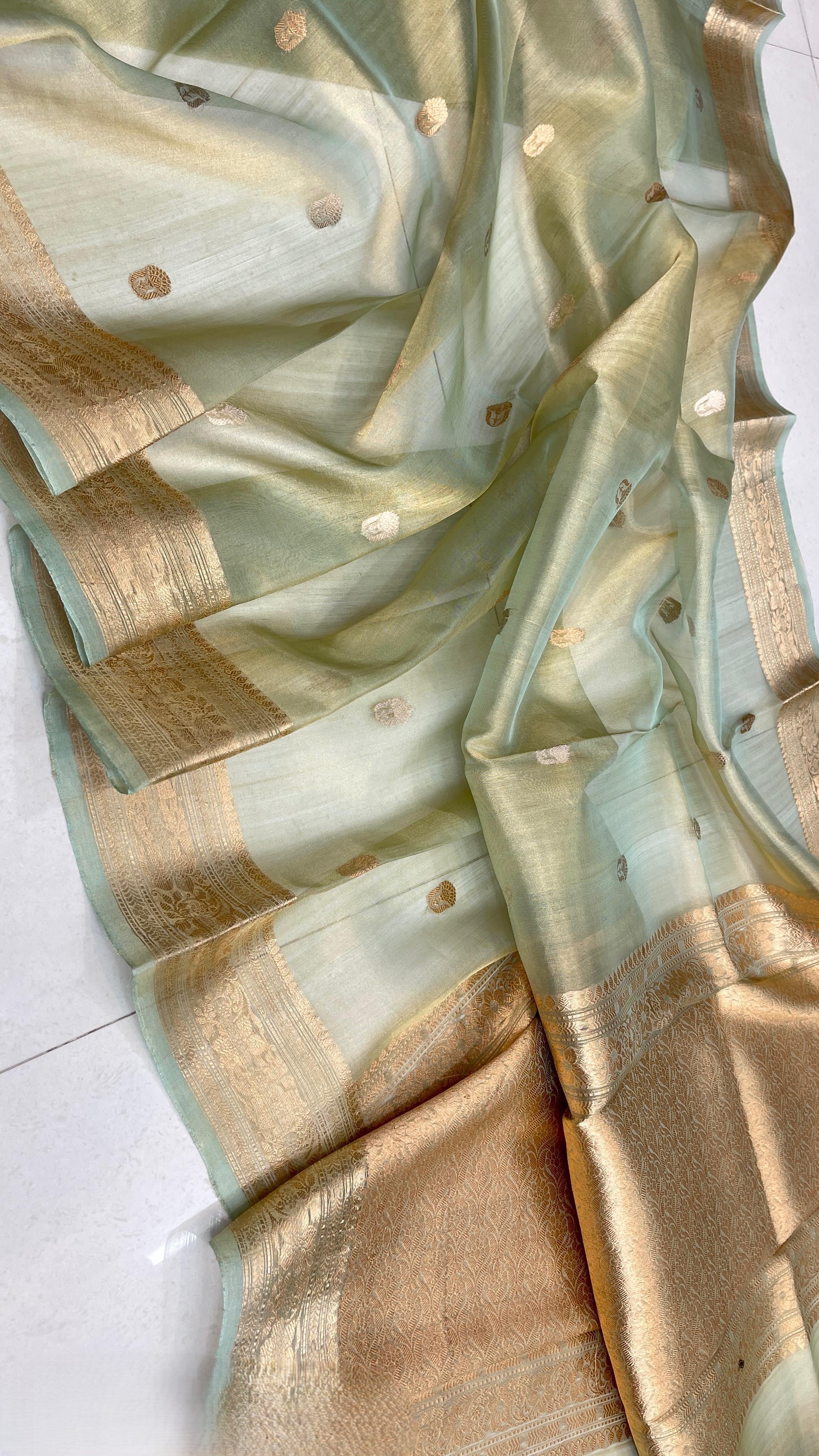 Pista Green Banarasi handloom kora tissue silk saree featuring shimmering antique zari weaving, delicate body buttas, and a certified authentic finish.