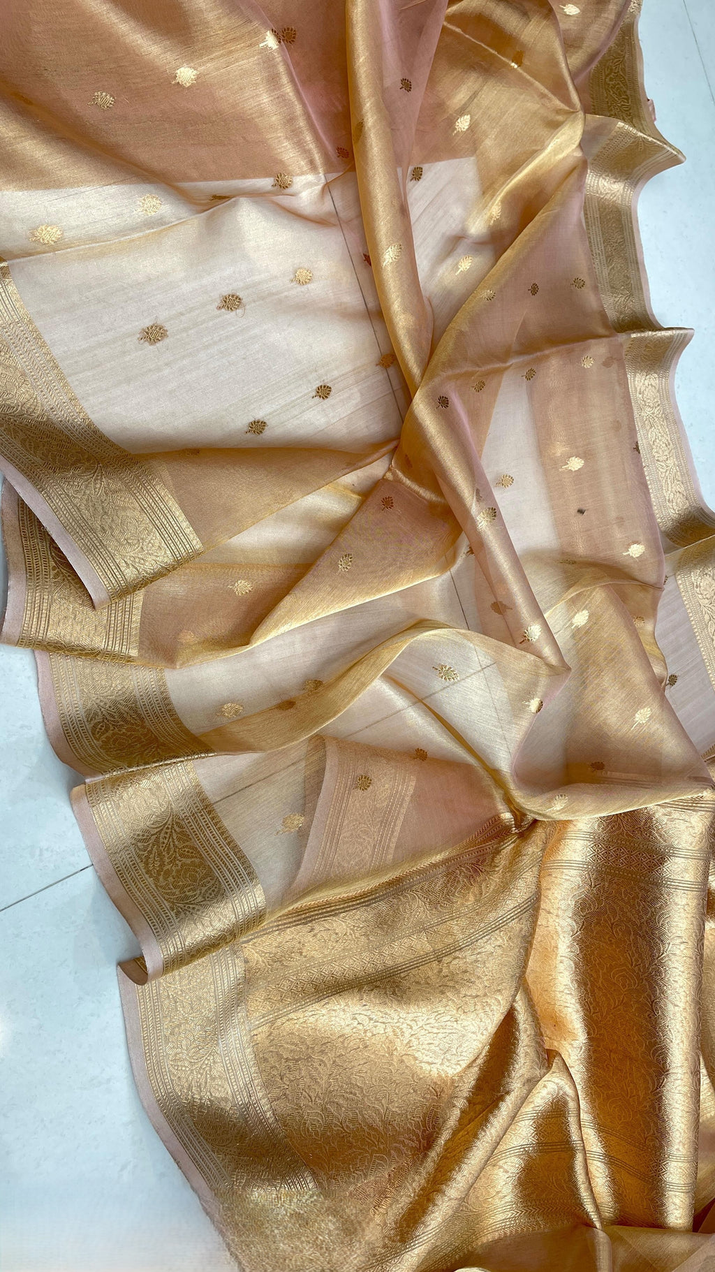 Gold Banarasi handloom kora tissue silk saree featuring shimmering antique zari weaving, delicate body buttas, and a certified authentic finish.