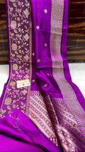 Vibrant purple Banarasi handloom raw mango silk saree featuring rich gold mashru borders and intricate Kaduwa weaving.