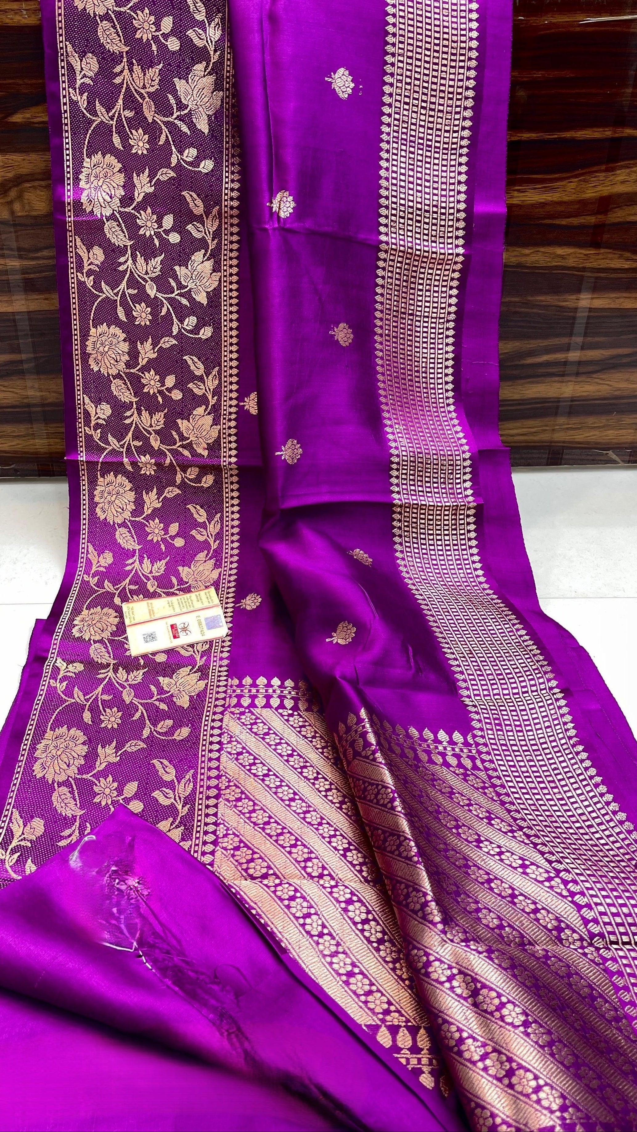 Vibrant purple Banarasi handloom raw mango silk saree featuring rich gold mashru borders and intricate Kaduwa weaving.