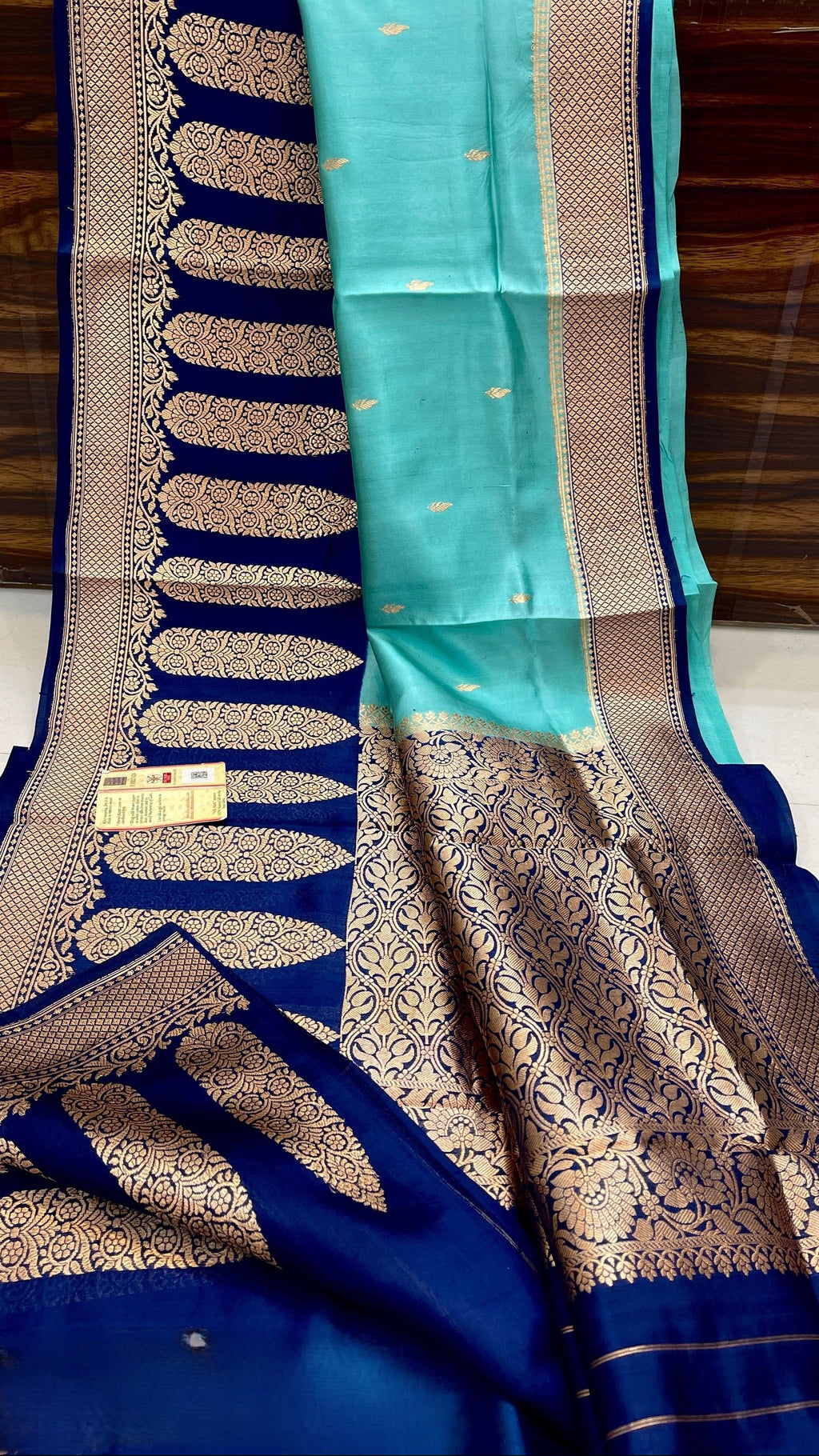 Turquoise Banarasi handloom raw mango silk saree featuring purple and gold mashru borders with intricate Kaduwa weaving.