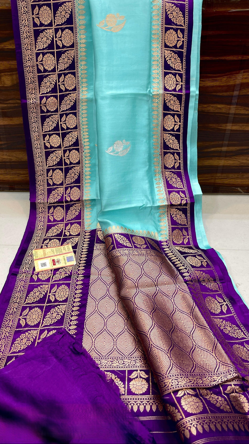 Turquoise Banarasi handloom raw mango silk saree featuring purple and gold mashru borders and intricate Meenakari work.