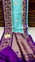 Turquoise Banarasi handloom raw mango silk saree featuring purple and gold mashru borders and intricate Meenakari work.