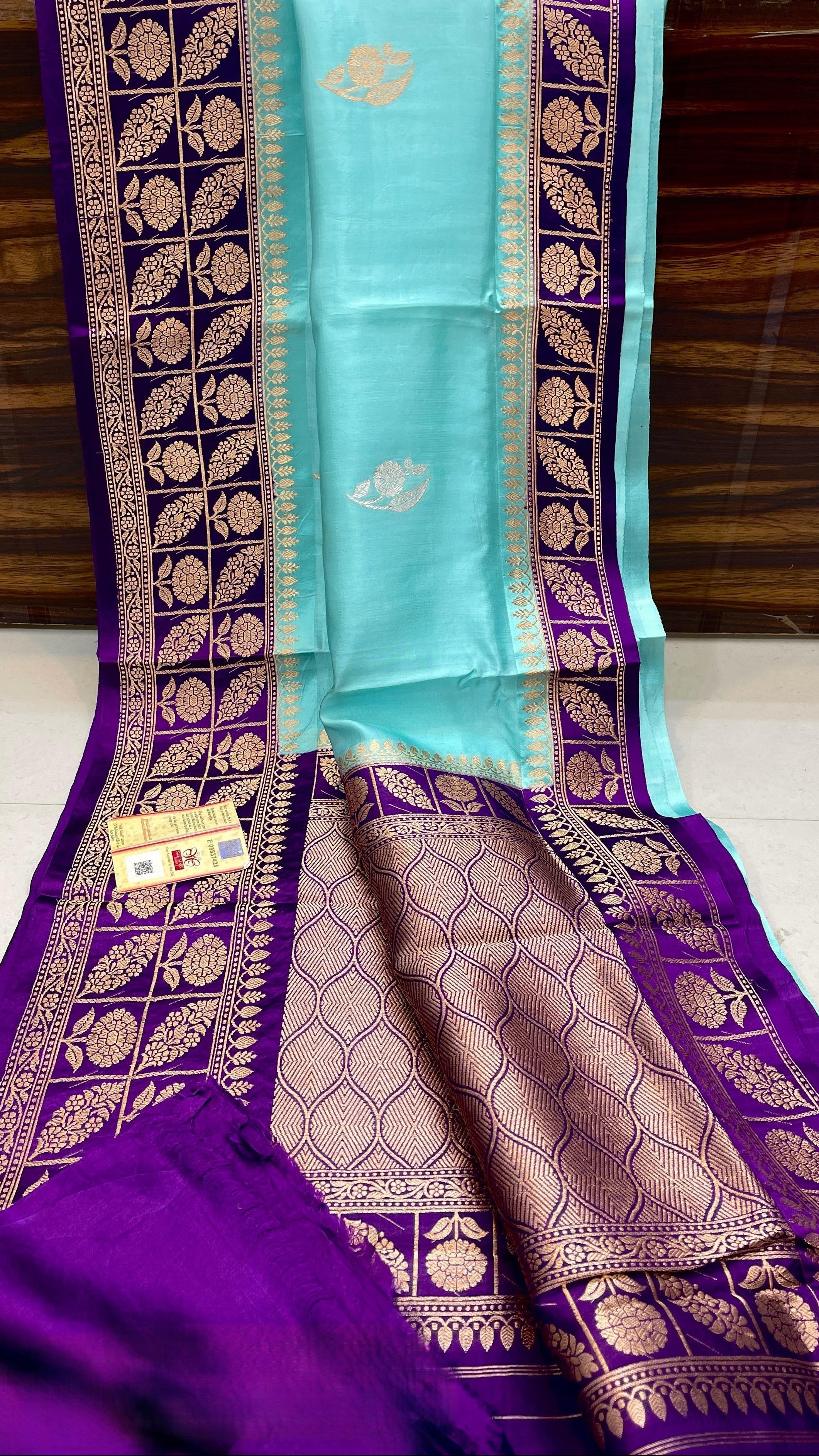 Turquoise Banarasi handloom raw mango silk saree featuring purple and gold mashru borders and intricate Meenakari work.