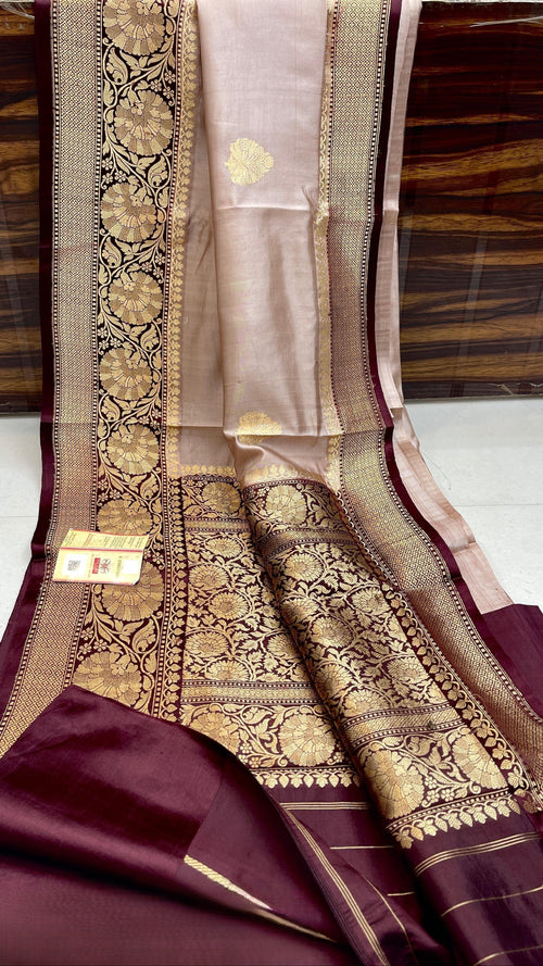 Elegant Beige Banarasi handloom raw mango silk saree with rich mashru borders and intricate Kaduwa weaving.