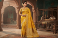 Model wearing a vibrant yellow Banarasi handloom pure georgette silk saree with intricate antique silver zari weaving against a traditional artisan background.