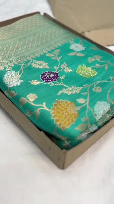 Elegant Teal Banarasi Handloom Katan silk saree with intricate multi-colored Meenakari floral motifs and detailed gold zari borders.