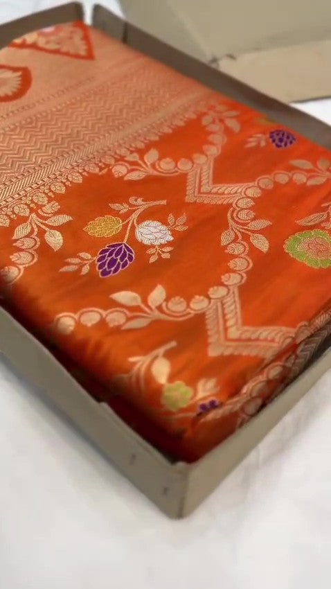 Elegant dual-tone orange Banarasi handloom Katan silk saree with intricate Meenakari floral weaving and gold zari borders.