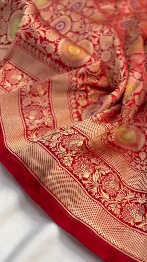 Chilly Red Banarasi Handloom Katan silk saree with intricate multicolored chakram motifs and ornate zari borders.