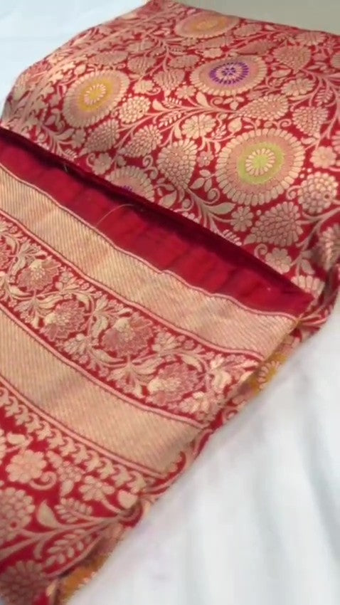 Chilly Red Banarasi Handloom Katan silk saree with intricate multicolored chakram motifs and ornate zari borders.