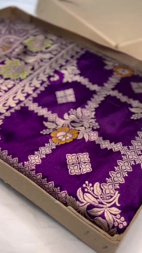 Regal Purple Banarasi Handloom Katan Silk saree with intricate multi-colored Meenakari floral motifs and detailed silver zari borders.