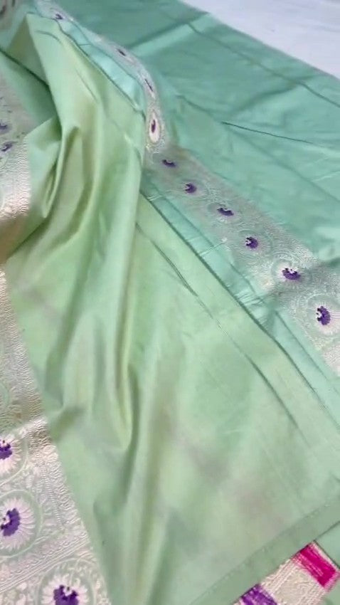 Pista Green Banarasi Handloom Katan Silk Saree With Intricate Multi-Colored Meenakari Floral Motifs And Detailed Silver Zari Borders.