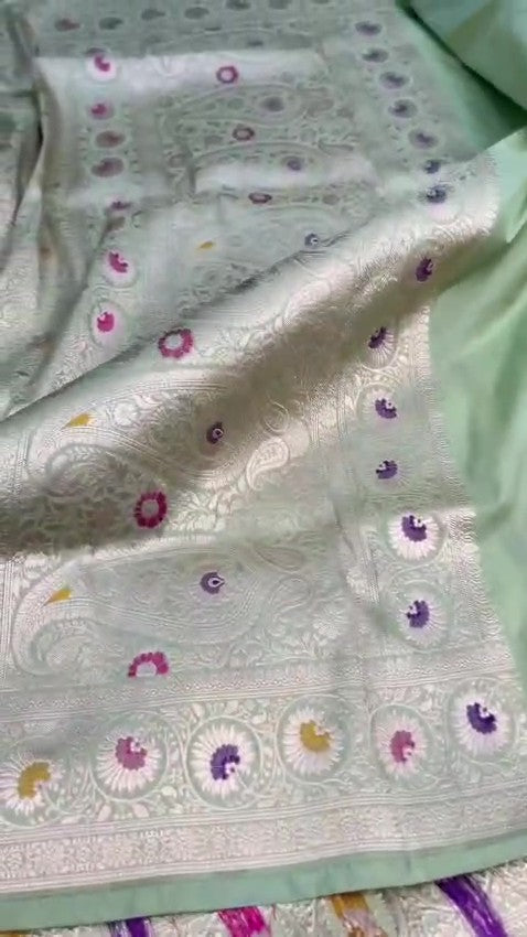 Pista Green Banarasi Handloom Katan Silk Saree With Intricate Multi-Colored Meenakari Floral Motifs And Detailed Silver Zari Borders.