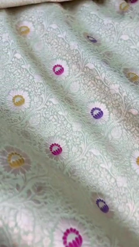 Pista Green Banarasi Handloom Katan Silk Saree With Intricate Multi-Colored Meenakari Floral Motifs And Detailed Silver Zari Borders.