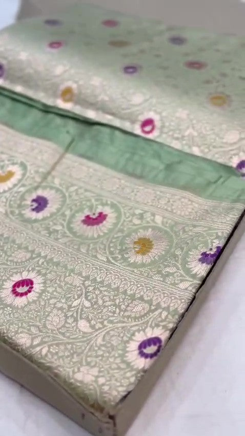 Pista Green Banarasi Handloom Katan Silk Saree With Intricate Multi-Colored Meenakari Floral Motifs And Detailed Silver Zari Borders.