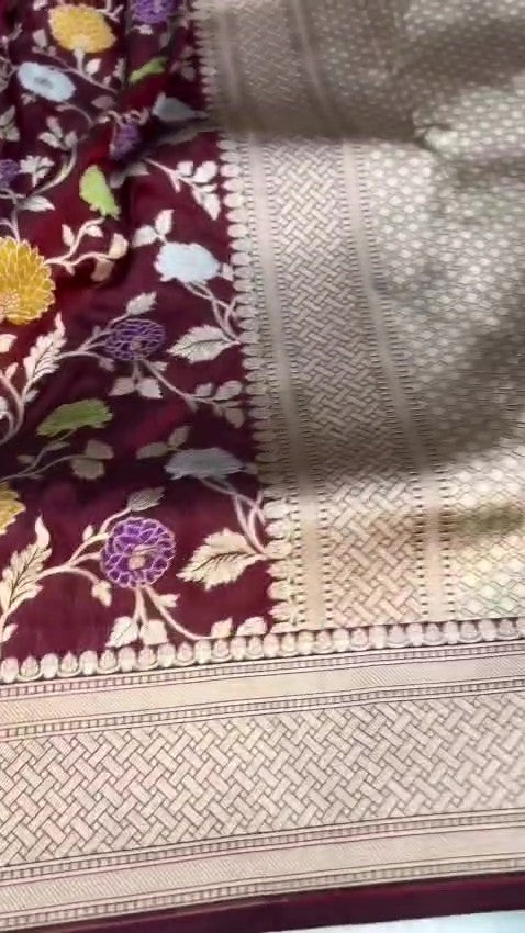 Burgundy Banarasi Handloom Katan Silk saree with elaborate multi-colored Meenakari floral motifs and grand gold zari borders.