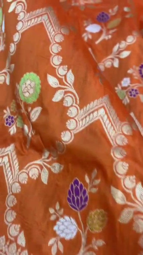 Elegant dual-tone orange Banarasi handloom Katan silk saree with intricate Meenakari floral weaving and gold zari borders.
