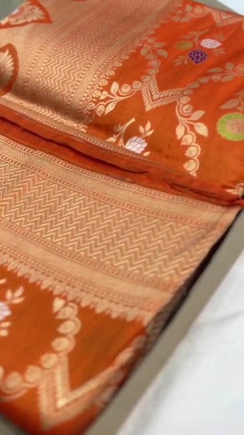 Elegant dual-tone orange Banarasi handloom Katan silk saree with intricate Meenakari floral weaving and gold zari borders.