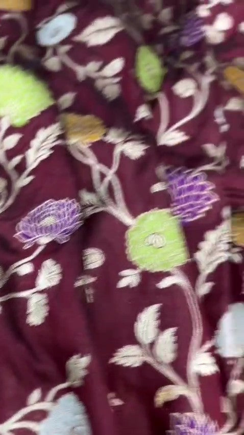 Burgundy Banarasi Handloom Katan Silk saree with elaborate multi-colored Meenakari floral motifs and grand gold zari borders.