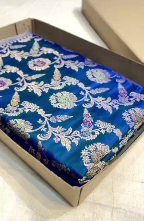 Peacock blue Banarasi handloom pure katan silk saree featuring intricate silver zari weaving and colorful Meenakari floral motifs