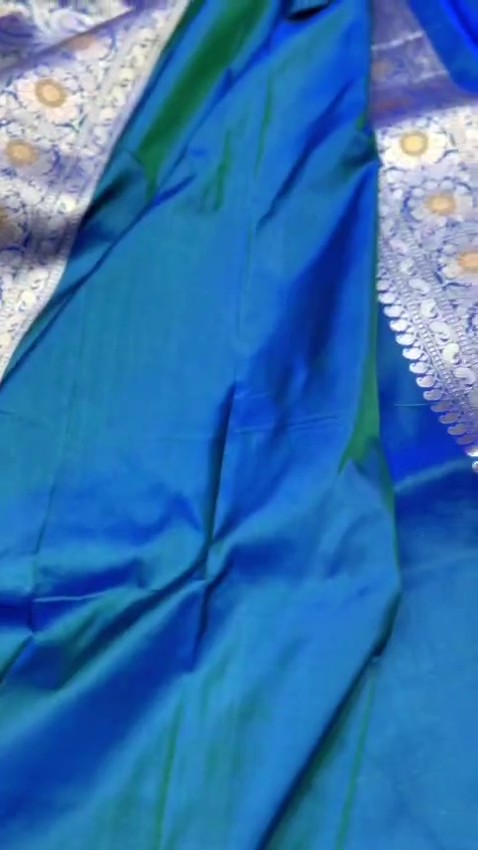 Peacock blue Banarasi handloom pure katan silk saree featuring intricate silver zari weaving and colorful Meenakari floral motifs