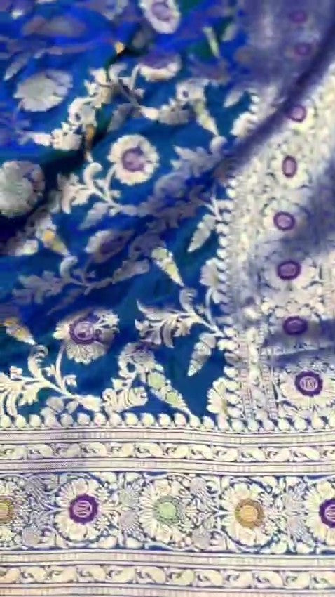 Peacock blue Banarasi handloom pure katan silk saree featuring intricate silver zari weaving and colorful Meenakari floral motifs