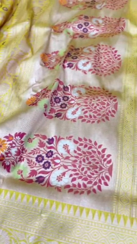 A vibrant turmeric yellow Banarasi handloom pure Katan silk saree with multicolored Meenakari floral bootis and a rich silver zari border, ideal for Haldi functions.