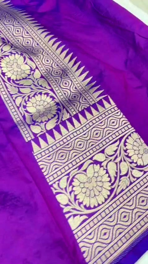 A deep royal purple Banarasi handloom pure Katan silk saree featuring vibrant multicolored Meenakari floral motifs and an elaborate silver zari border and pallu.