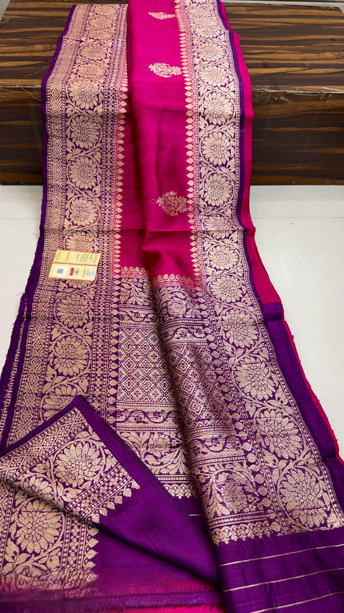 Banarasi handloom raw silk Kaduwa saree featuring intricate gold zari floral motifs and rich contrast borders, available in multiple color options with Silk Mark certification.