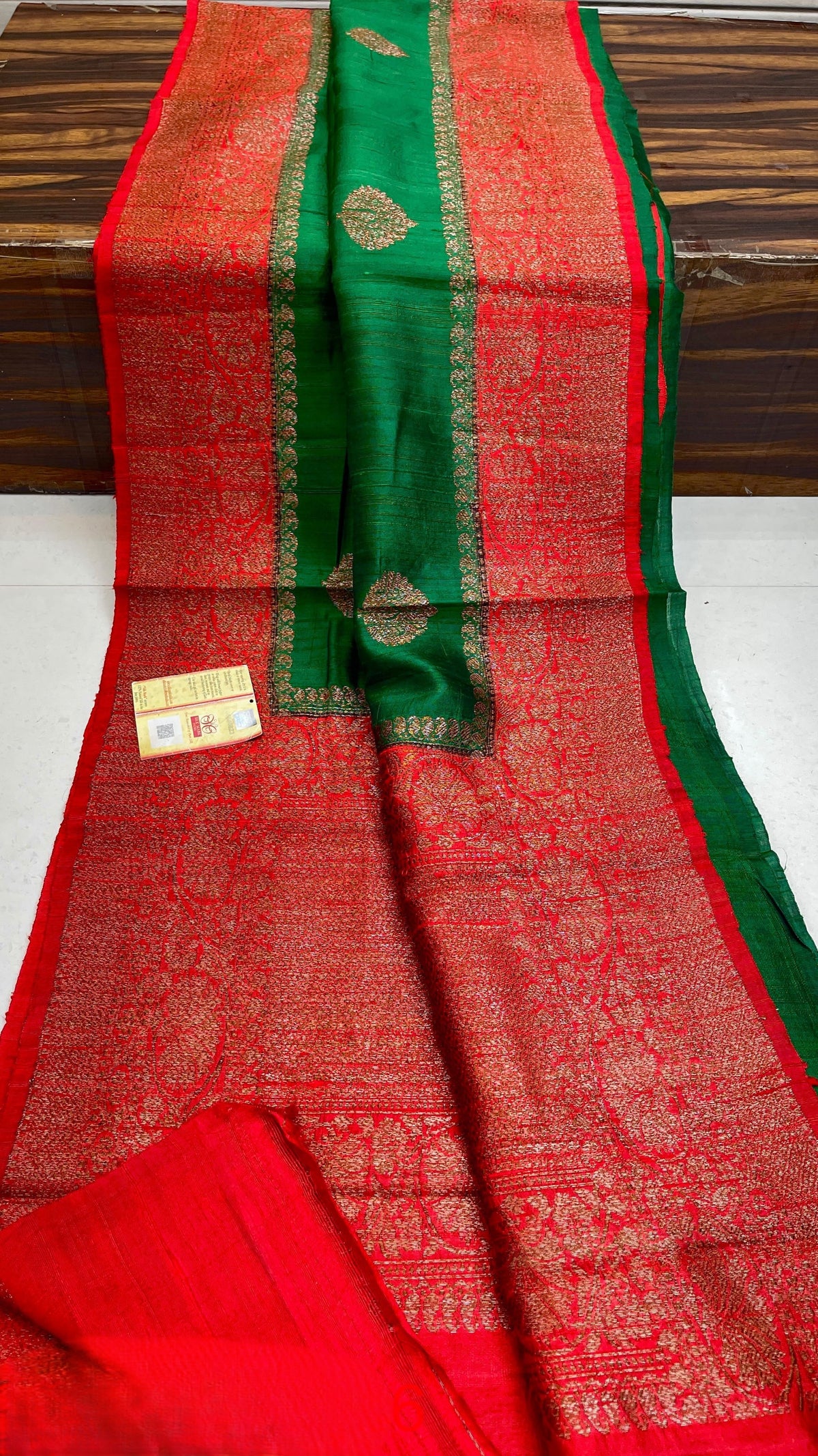 Banarasi handloom raw silk Kaduwa saree featuring intricate gold zari floral motifs and rich contrast borders, available in multiple color options with Silk Mark certification.