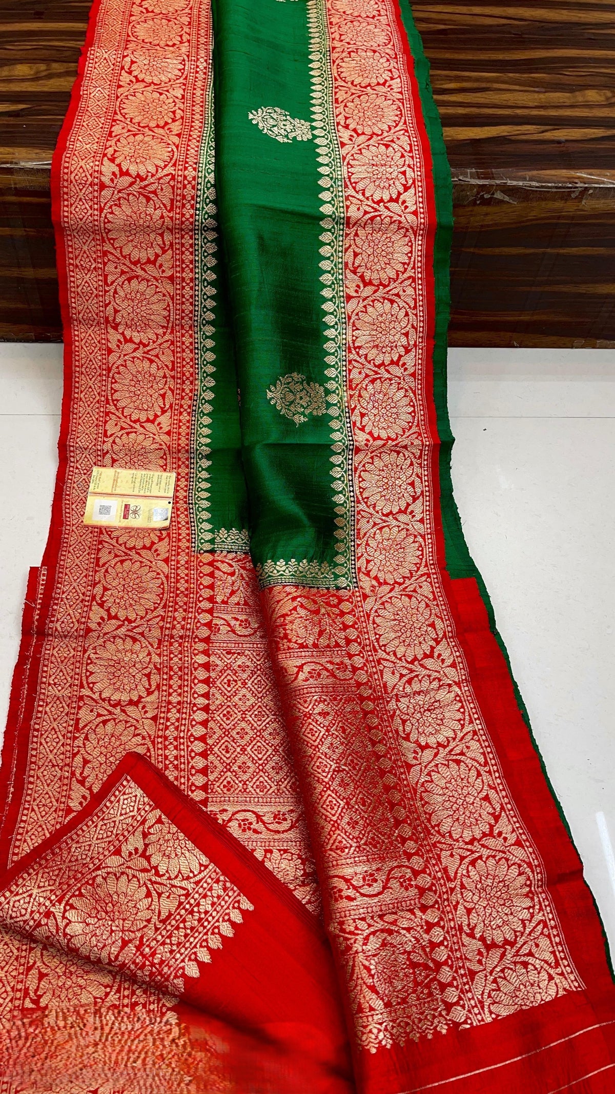 Banarasi handloom raw silk Kaduwa saree featuring intricate gold zari floral motifs and rich contrast borders, available in multiple color options with Silk Mark certification.
