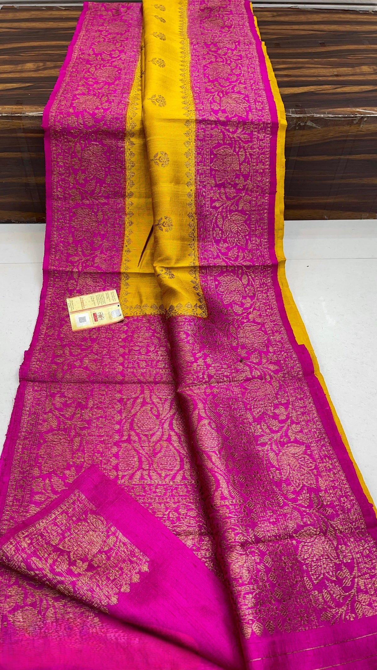 Banarasi handloom raw silk Kaduwa saree featuring intricate gold zari floral motifs and rich contrast borders, available in multiple color options with Silk Mark certification.