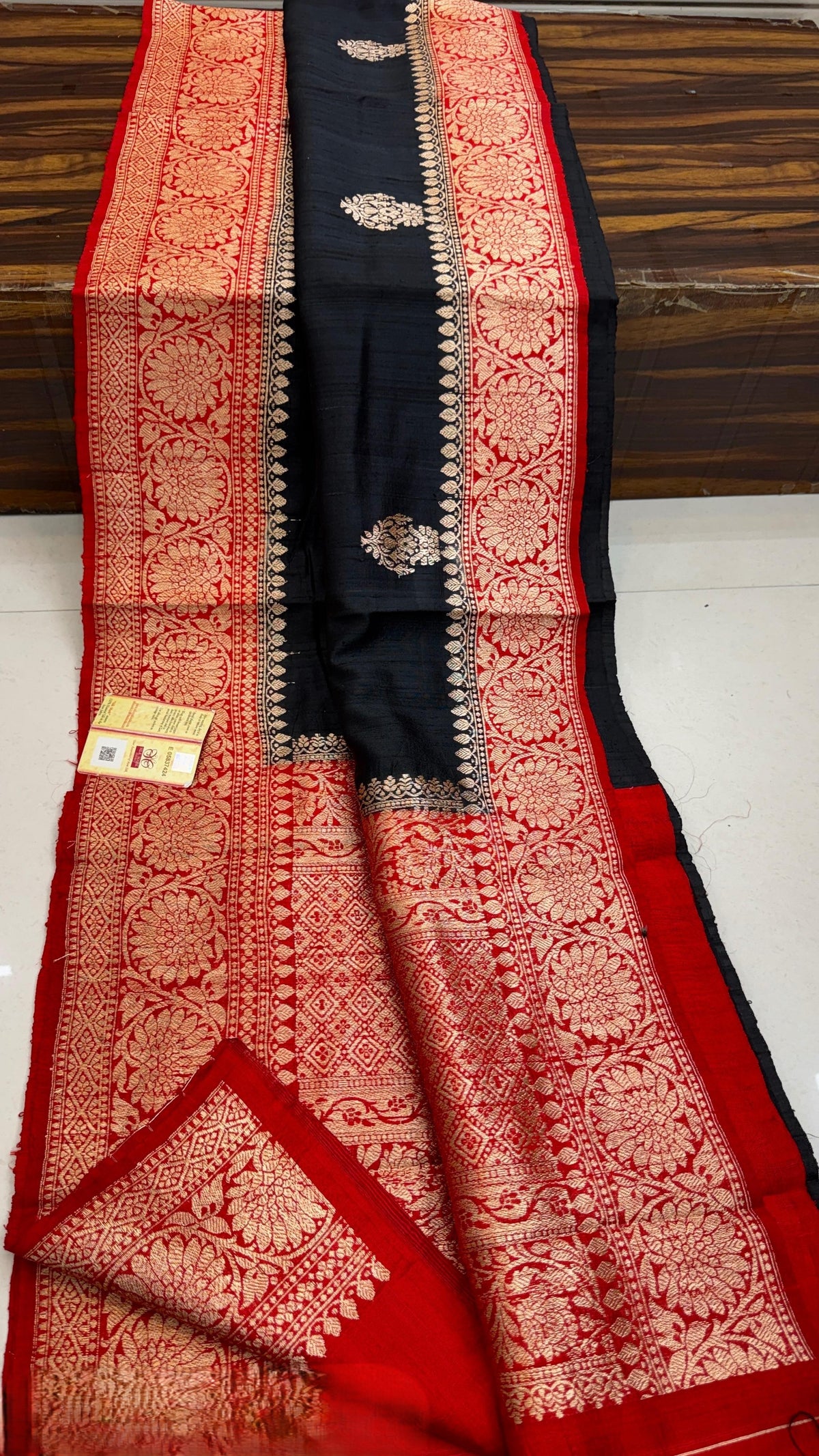 Banarasi handloom raw silk Kaduwa saree featuring intricate gold zari floral motifs and rich contrast borders, available in multiple color options with Silk Mark certification.
