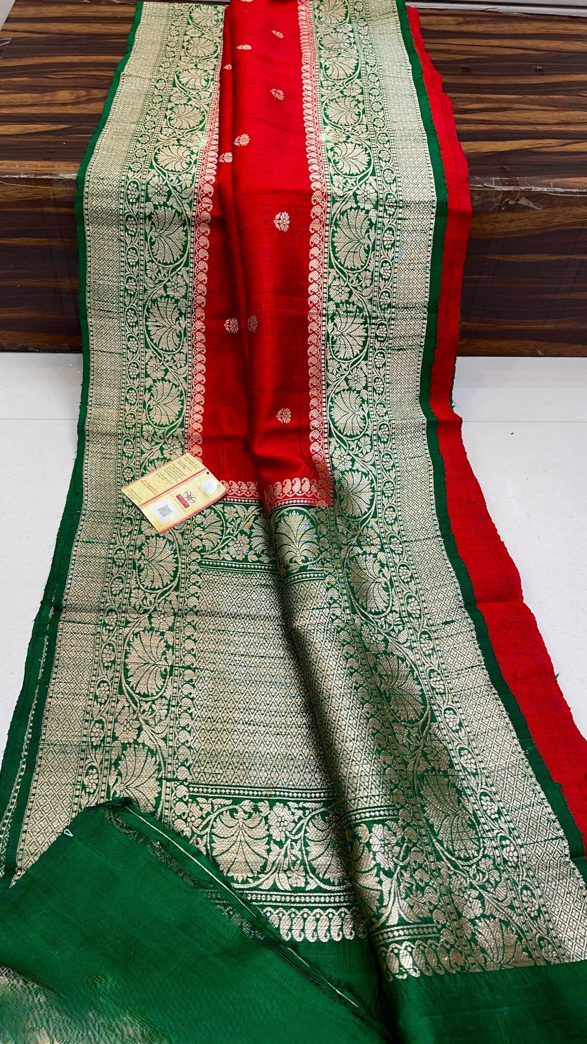 Banarasi handloom raw silk Kaduwa saree featuring intricate gold zari floral motifs and rich contrast borders, available in multiple color options with Silk Mark certification.
