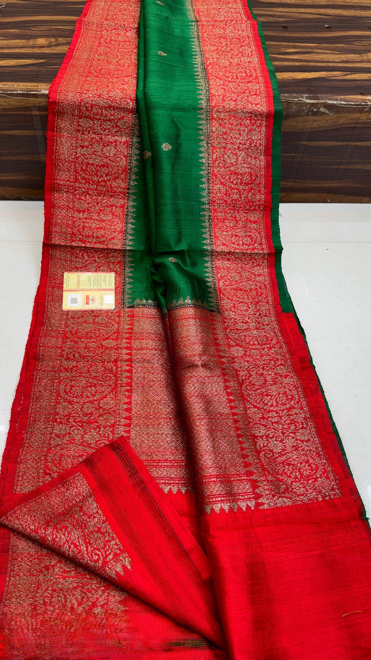 Banarasi handloom raw silk Kaduwa saree featuring intricate gold zari floral motifs and rich contrast borders, available in multiple color options with Silk Mark certification.