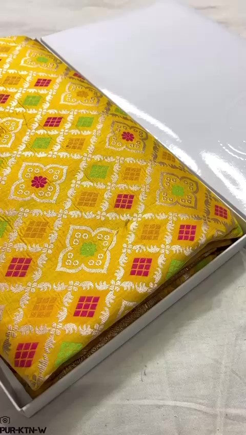 Radiant yellow Banarasi handloom pure katan silk saree featuring intricate gold zari and meenakari weaving