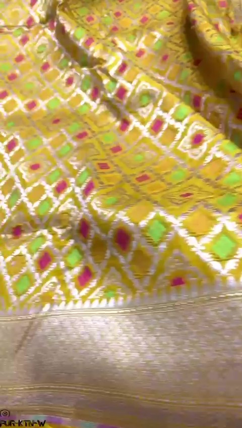Radiant yellow Banarasi handloom pure katan silk saree featuring intricate gold zari and meenakari weaving