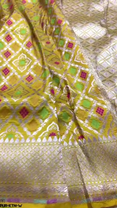 Radiant yellow Banarasi handloom pure katan silk saree featuring intricate gold zari and meenakari weaving