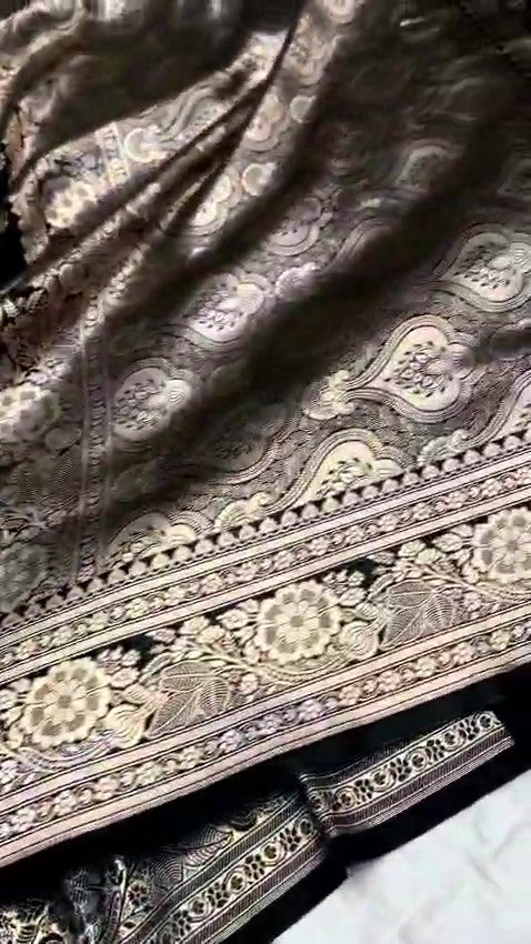 Black Banarasi Mashru soft silk saree featuring intricate copper zari floral buttas and an ornate zari border.