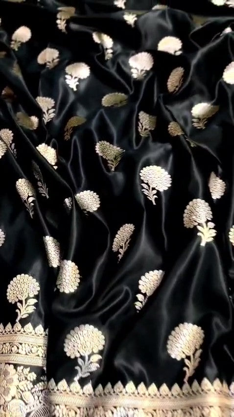 Black Banarasi Mashru soft silk saree featuring intricate copper zari floral buttas and an ornate zari border.
