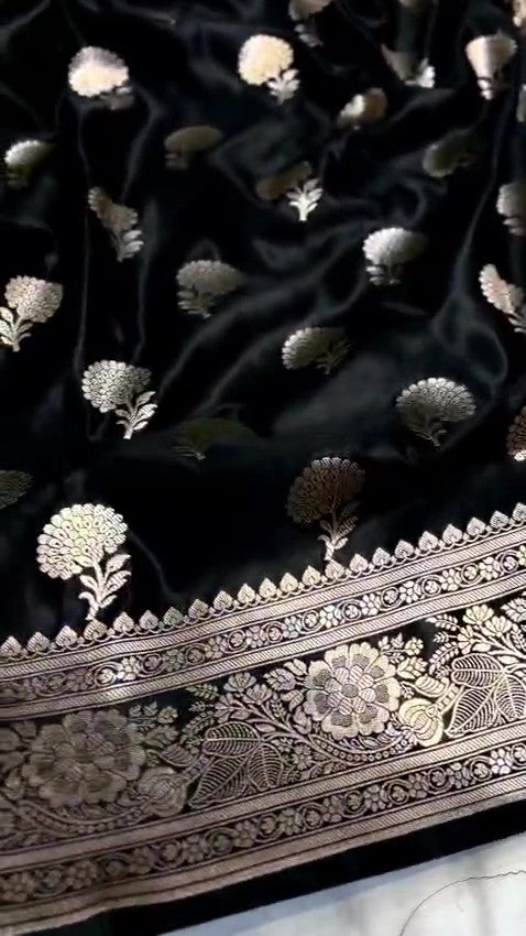 Black Banarasi Mashru soft silk saree featuring intricate copper zari floral buttas and an ornate zari border.