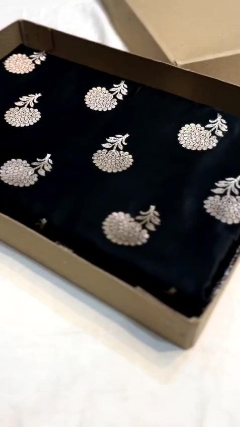 Black Banarasi Mashru soft silk saree featuring intricate copper zari floral buttas and an ornate zari border.