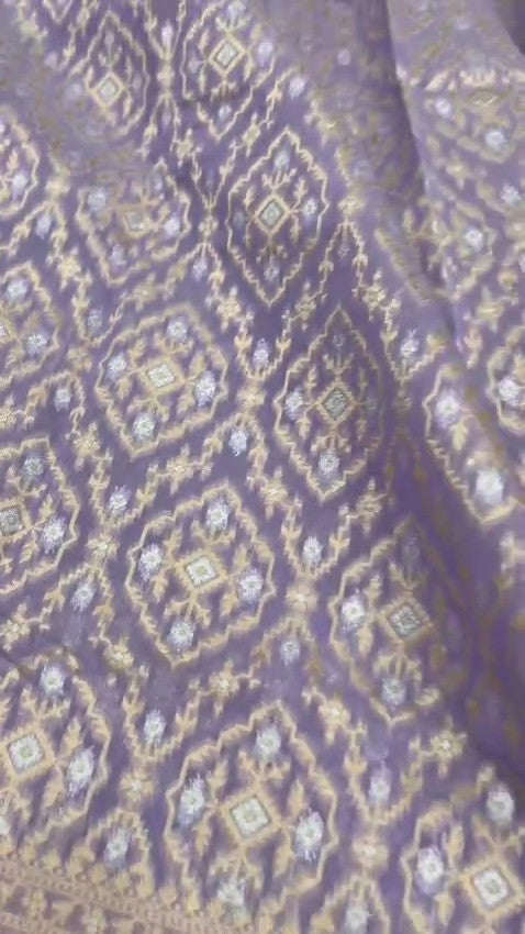  lavender Banarasi mercerised cotton saree with intricate gold and silver Sona Rupa zari weaving, posed beautifully in an elegant setting.