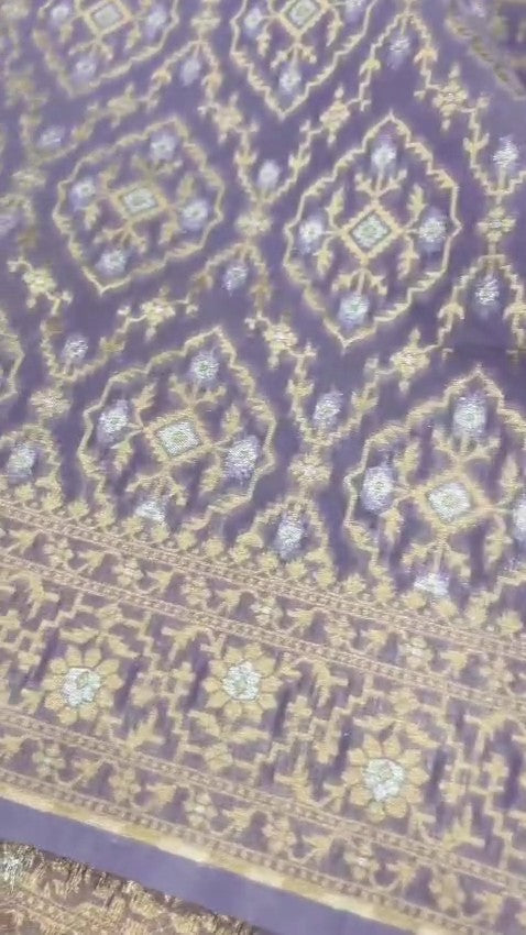 Lavender Banarasi mercerised cotton saree with intricate gold and silver Sona Rupa zari weaving, posed beautifully in an elegant setting.