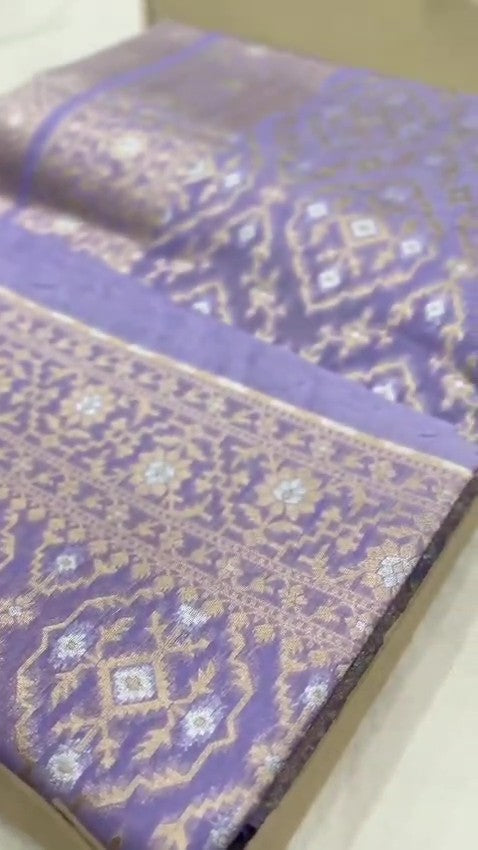 Lavender Banarasi mercerised cotton saree with intricate gold and silver Sona Rupa zari weaving, posed beautifully in an elegant setting.