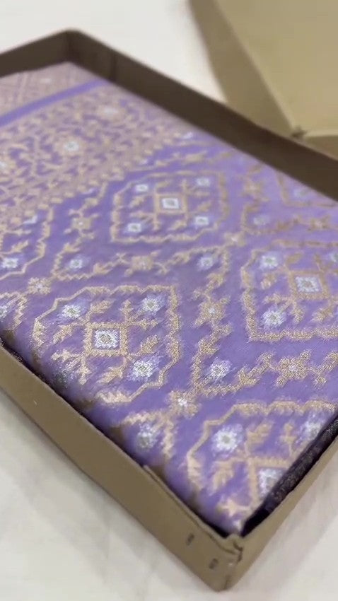 Lavender Banarasi mercerised cotton saree with intricate gold and silver Sona Rupa zari weaving, posed beautifully in an elegant setting.