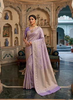 A model showcasing a lavender Banarasi mercerised cotton saree with intricate gold and silver Sona Rupa zari weaving, posed beautifully in an elegant setting.